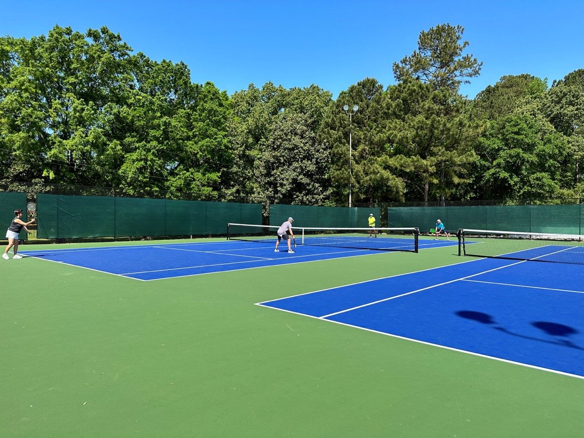 Players using blue and green courts at Action Park in Fuquay-Varina