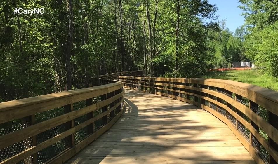 Curving wooden boardwalk on White Oak Creek Greenway in Cary