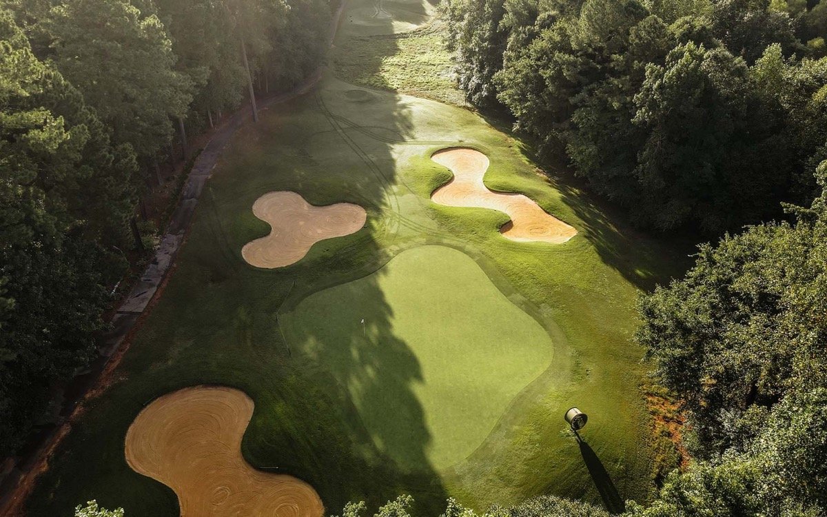 Aerial view of a green and sculpted bunkers at Devils Ridge Golf Club
