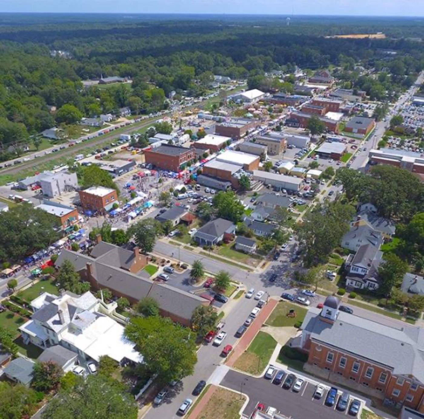 Aerial view of a festival and historic storefronts in Downtown Clayton