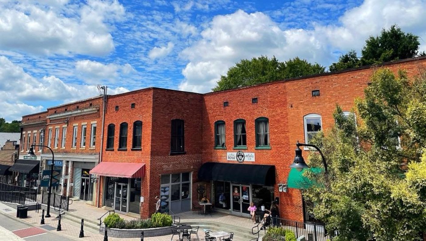 Historic brick storefronts and sidewalk seating in Downtown Wake Forest