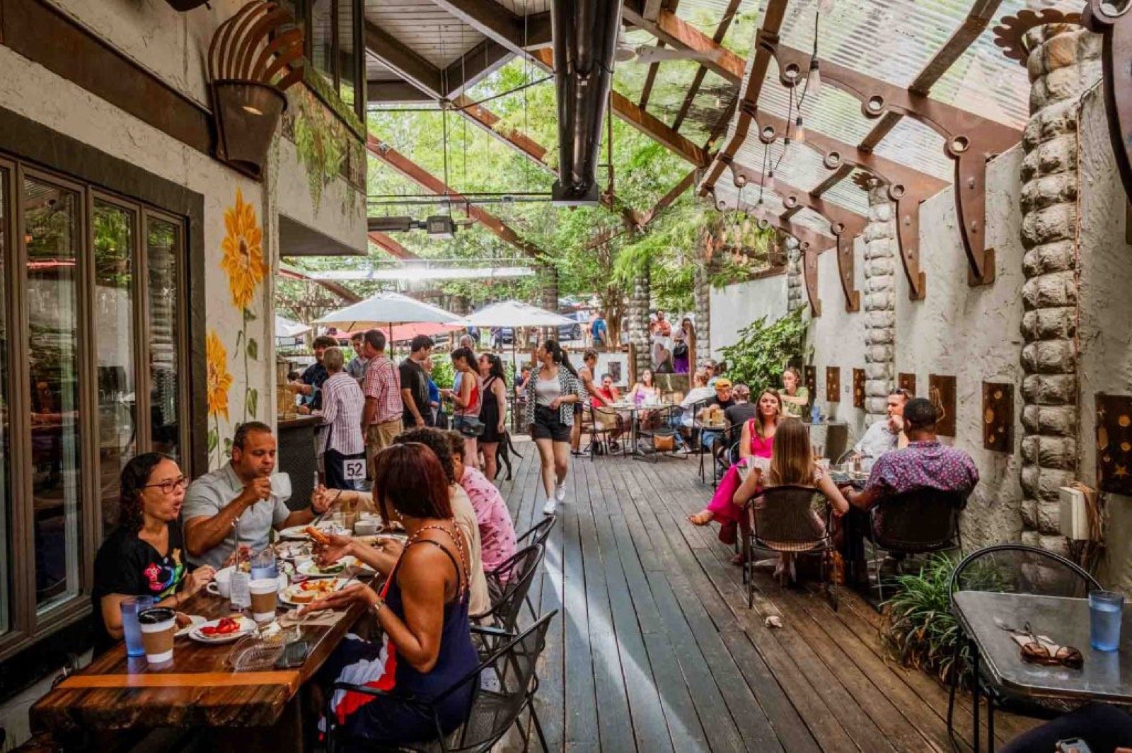 Guests dining on the wooded patio at Guglhupf in Durham