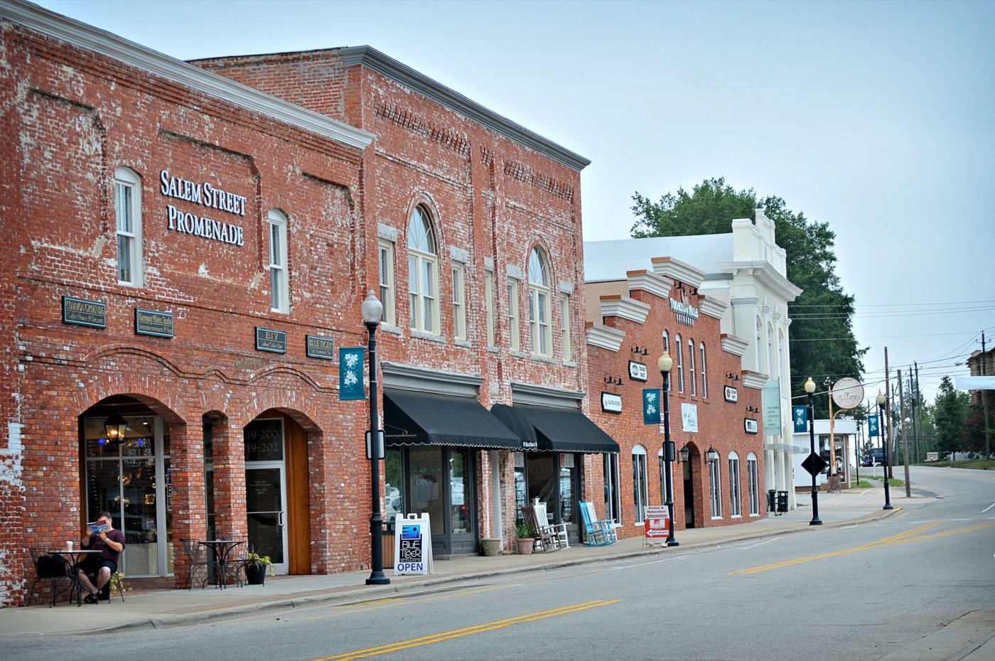 Brick storefronts and outdoor seating along the Salem Street Promenade in Apex
