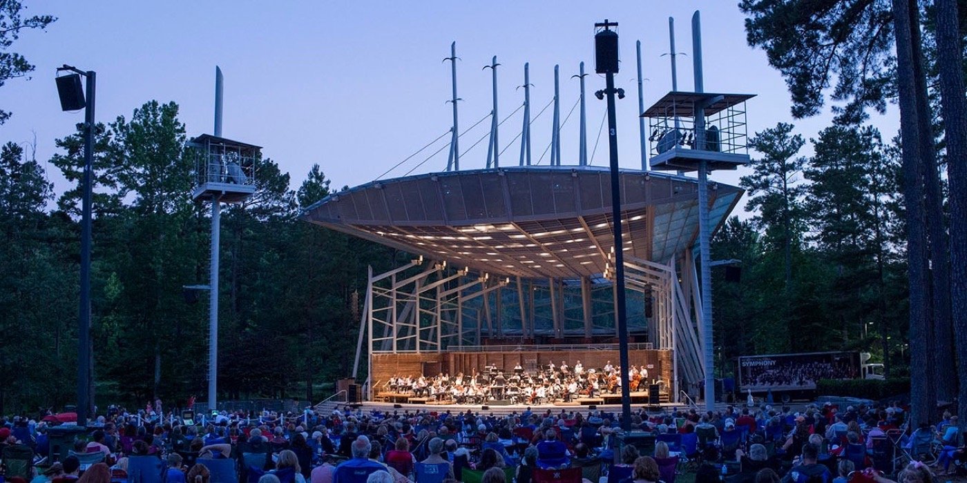 North Carolina Symphony performing for a lawn audience at Koka Booth Amphitheatre