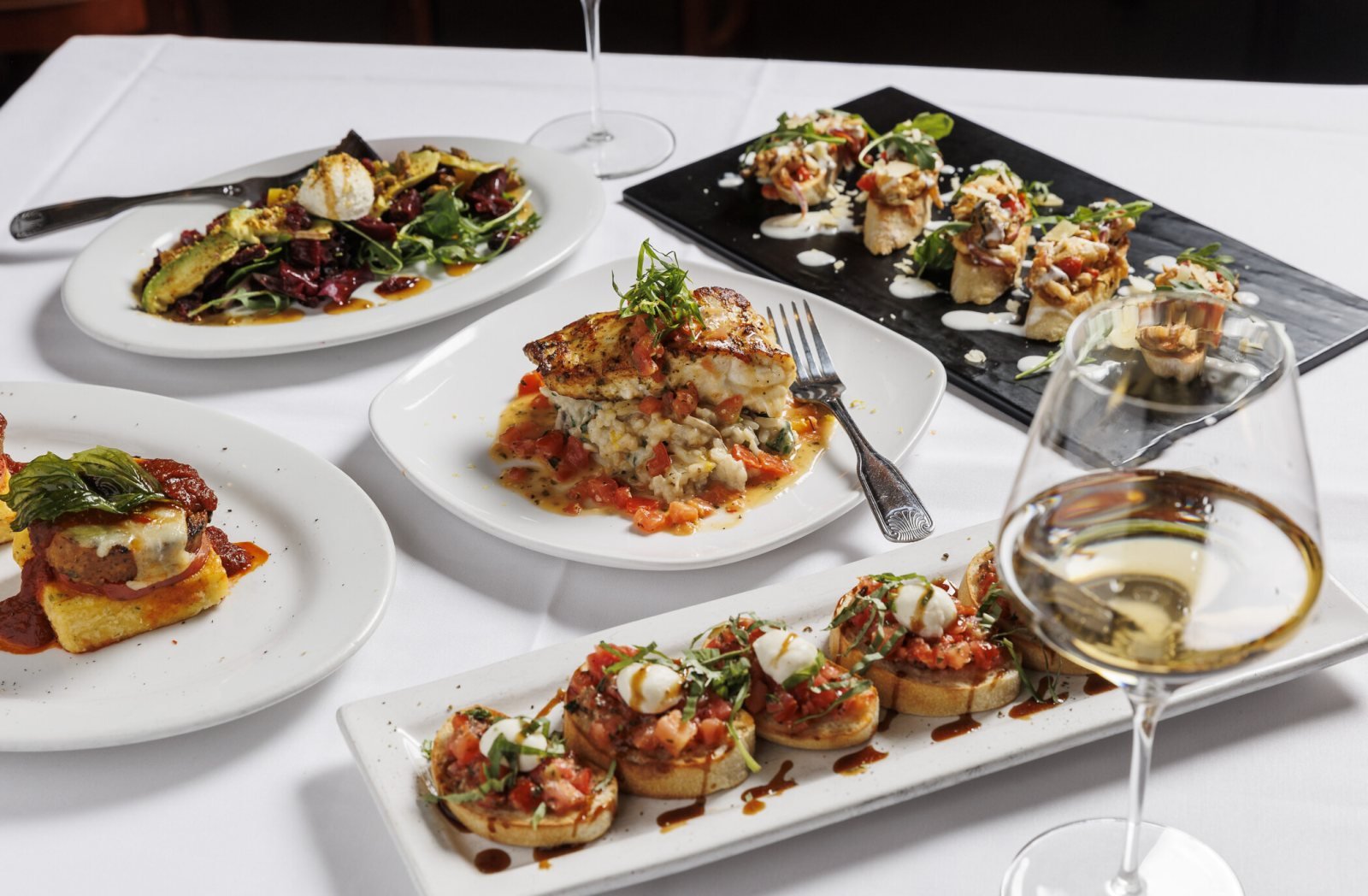 A table of Italian dishes at Lugano Ristorante in Cary
