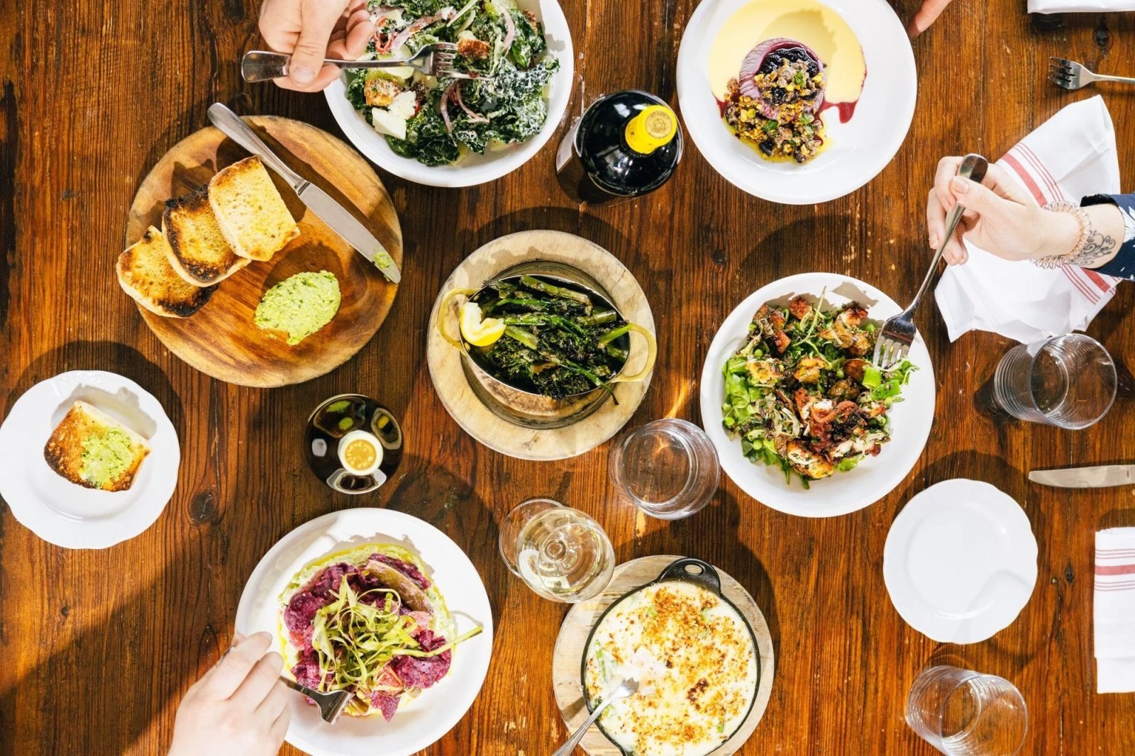 Italian dishes arranged across a table at Mothers and Sons Trattoria