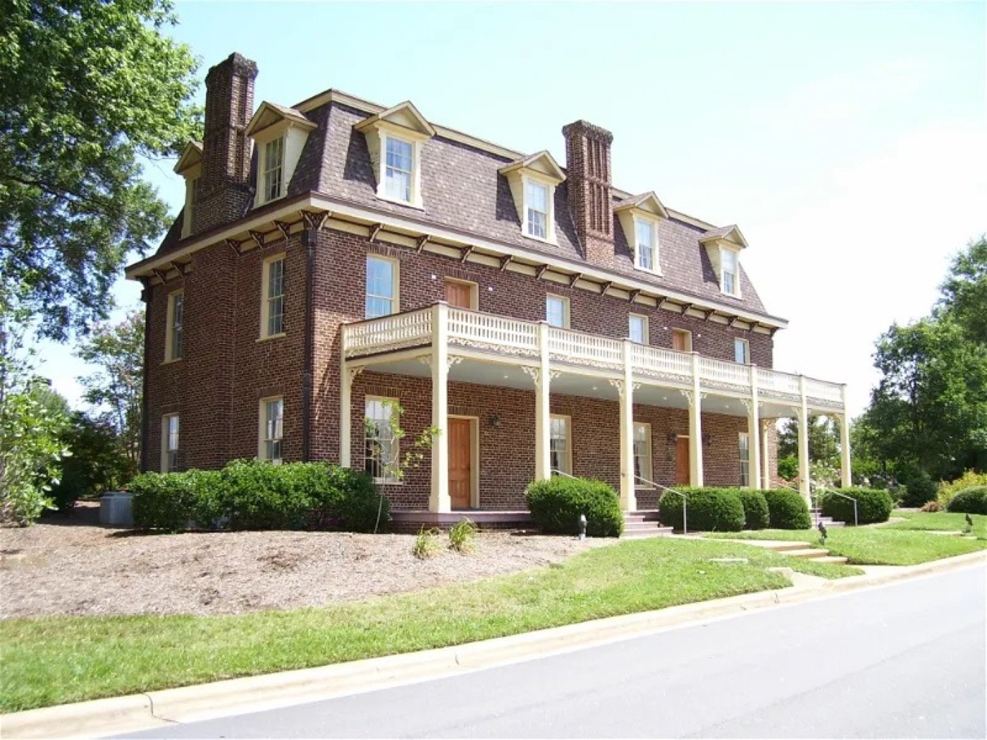 Restored brick Page-Walker Arts and History Center with its wraparound porch