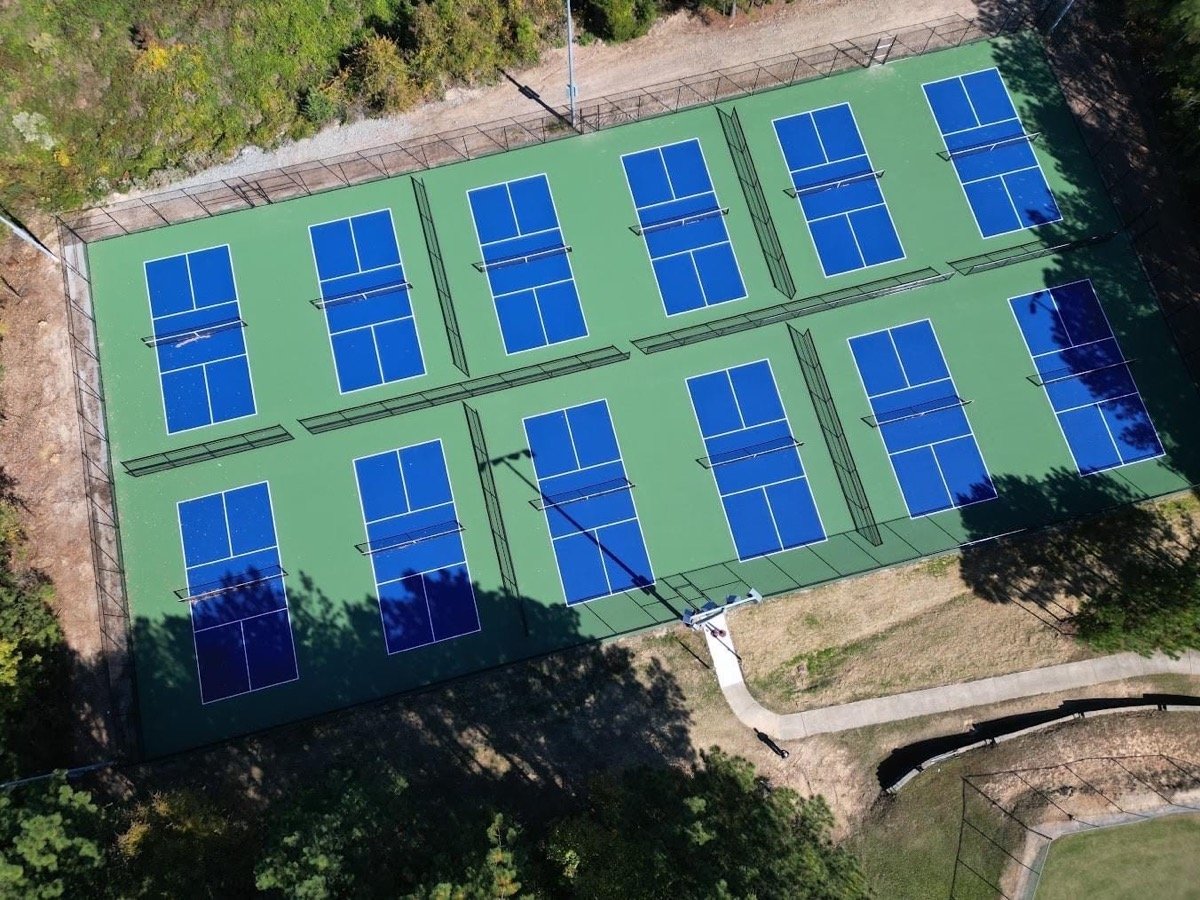 Aerial view of twelve dedicated pickleball courts at Piney Wood Park