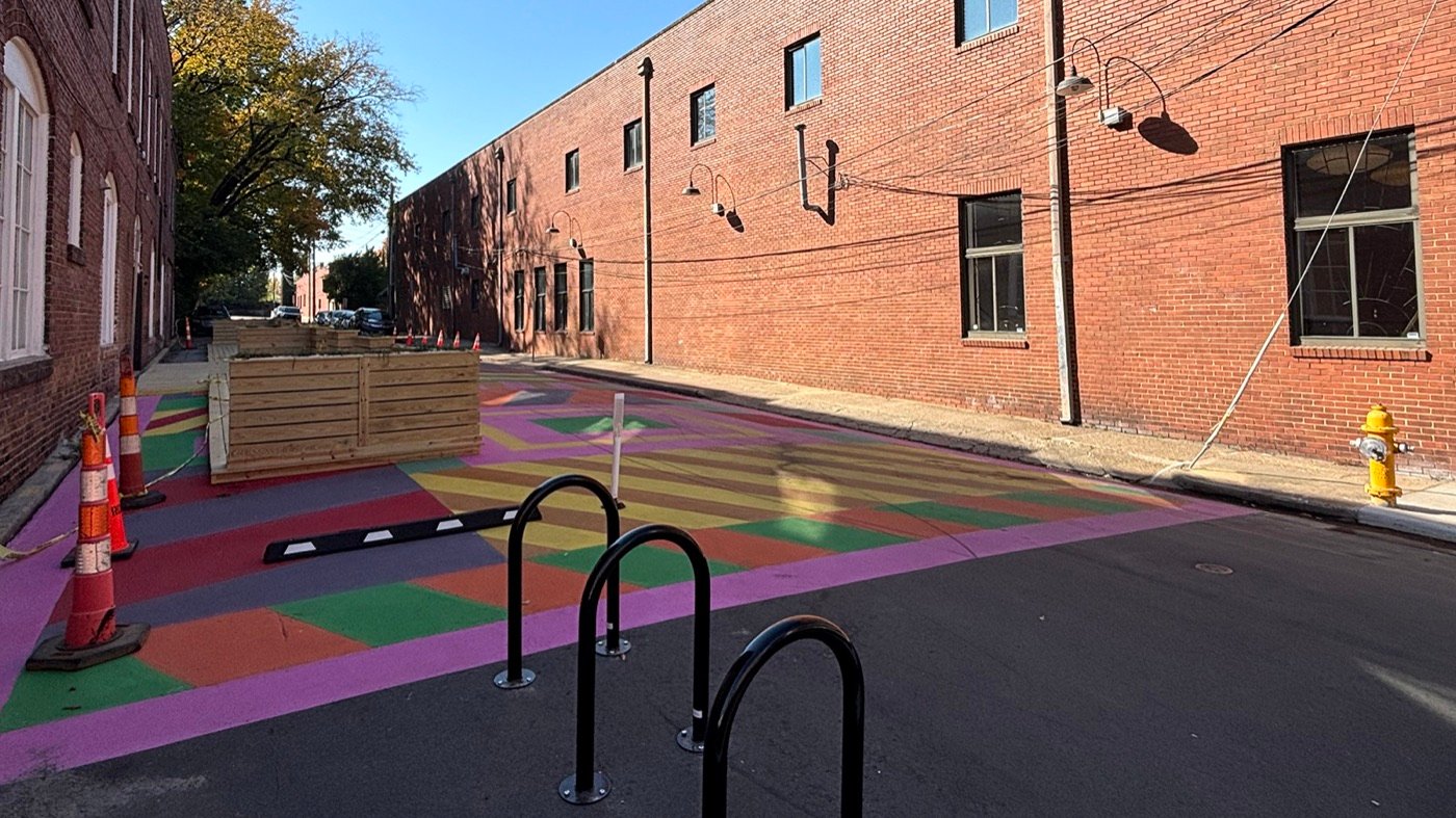 Colorfully painted shared street between brick buildings in Raleigh’s Warehouse District