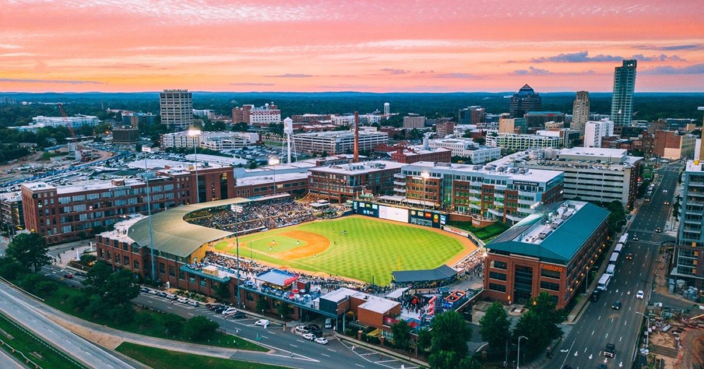 Aerial view of downtown Durham and the Durham Bulls ballpark at sunset