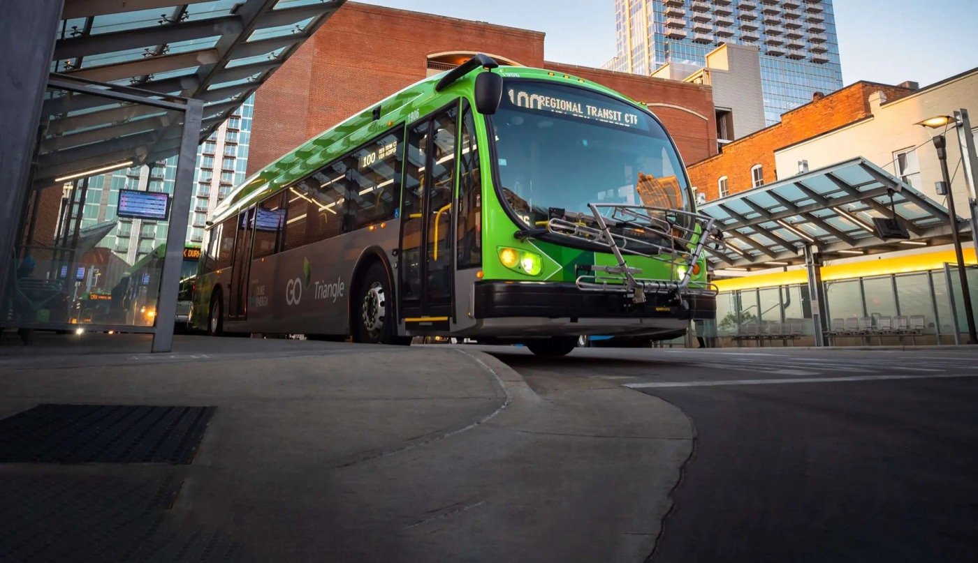 Green GoTriangle bus waiting at a regional transit platform