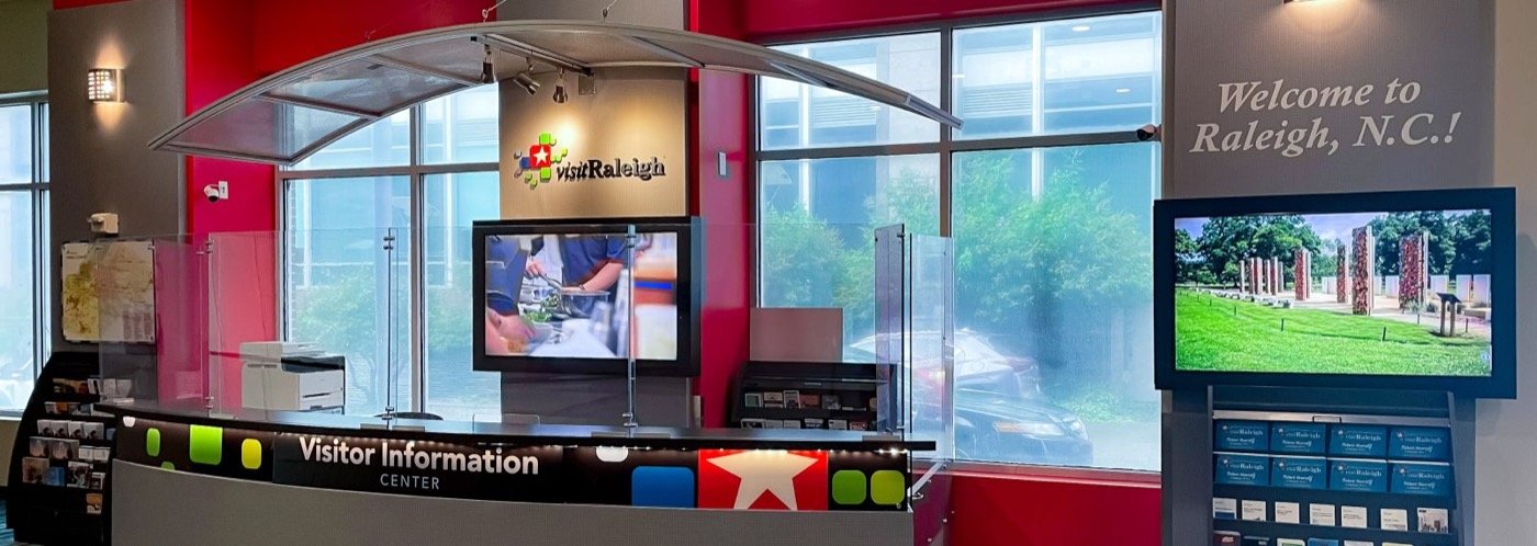 Visit Raleigh information desk with maps and digital displays