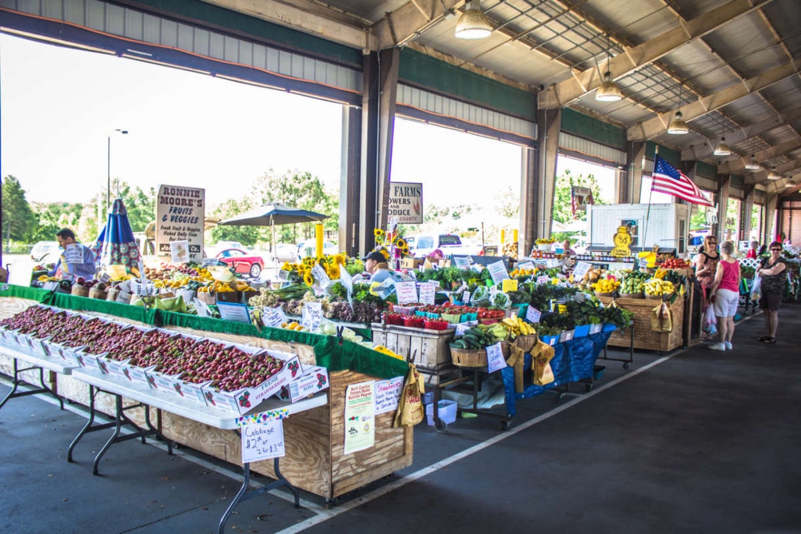 Produce and flower stalls inside the State Farmers Market in Raleigh