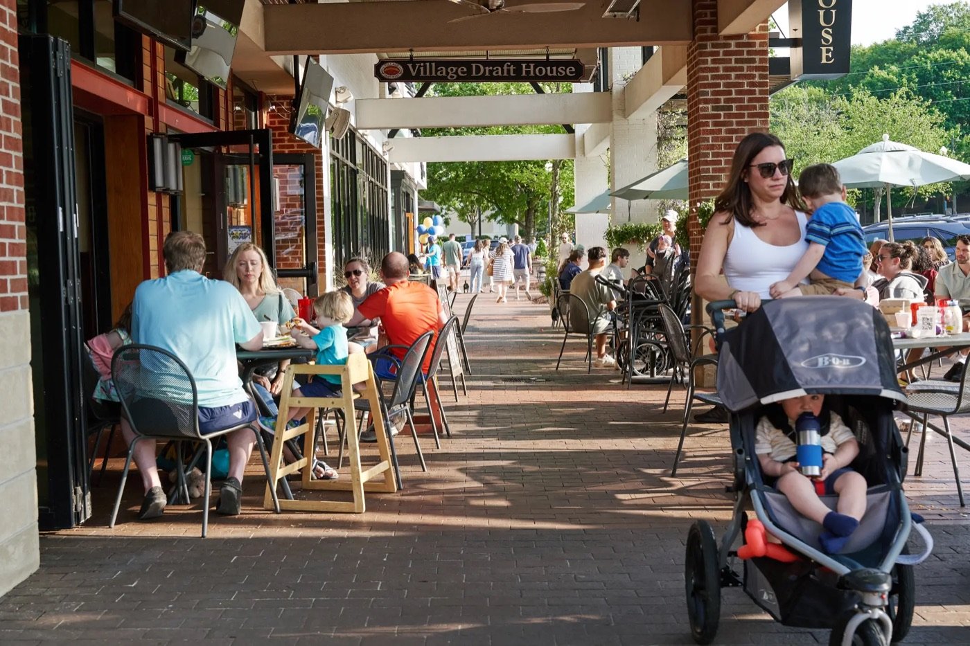 Pedestrian shopping and dining area decorated for the Village District anniversary