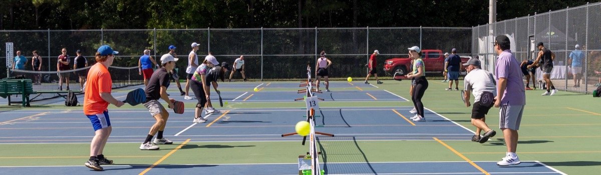 Multiple pickleball games in progress at Flaherty Park in Wake Forest