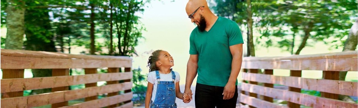 Father and daughter walking together on a Wendell Falls boardwalk