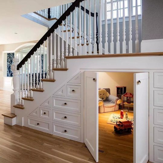 Children’s playroom and drawers built beneath a staircase